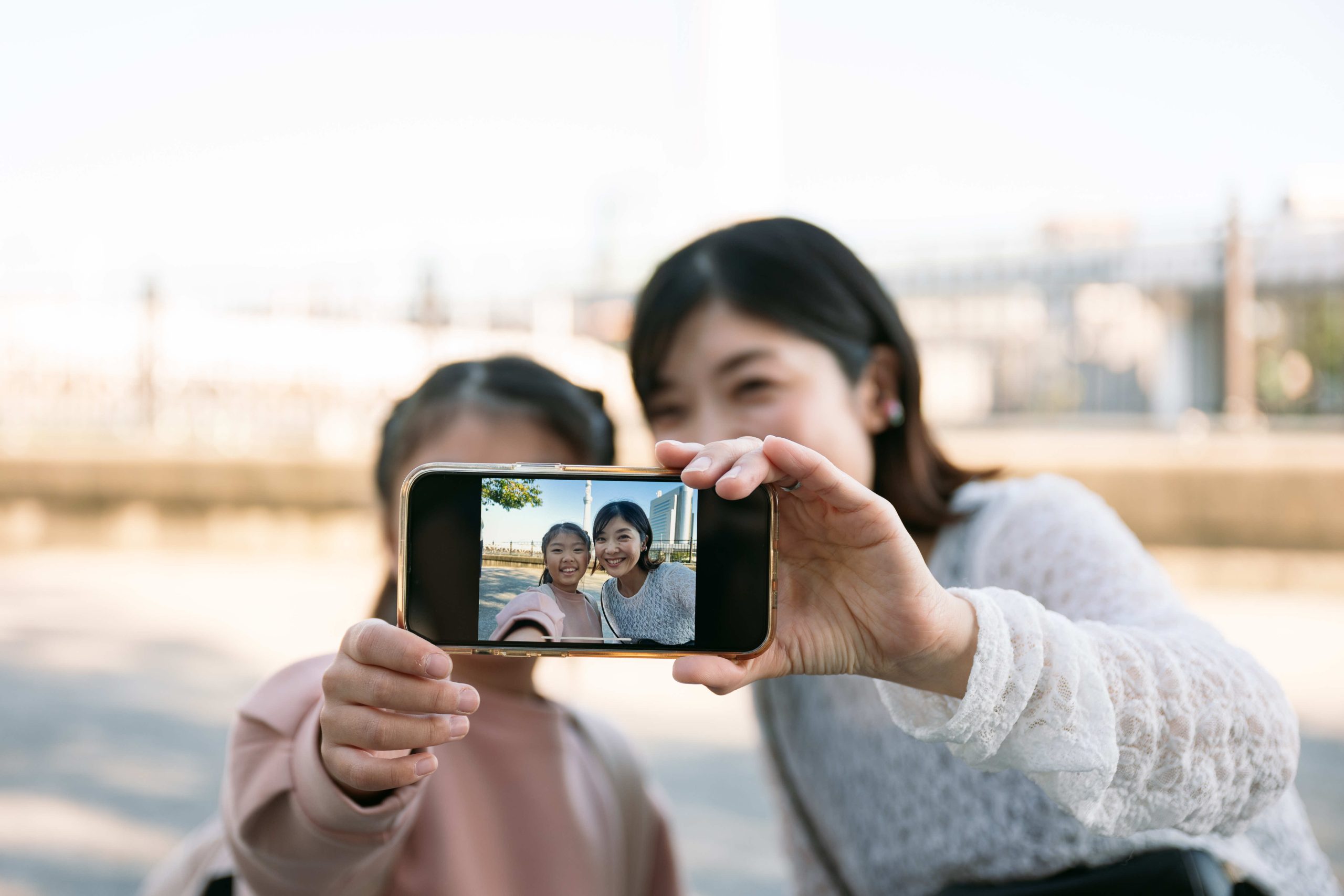 mother-and-daughter-taking-selfie-outdoors-with-sm-2025-04-12-05-19-58-utc